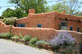 Adobe home behind wall near Canyon Road & Delgado St.. Santa Fe, NM.