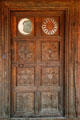 Carved door with moon & sun panels on Mexican Colonial House at Museum of Spanish Colonial Art. Santa Fe, NM.