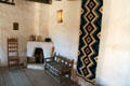 Corner fireplace & seats of reception room in La Placita at Rancho de las Golondrinas. Santa Fe, NM