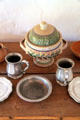 Covered pottery bowl plus pewter plates at Rancho de las Golondrinas. Santa Fe, NM.
