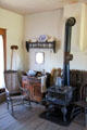 Rocking chair & stove in Raton schoolhouse at Rancho de las Golondrinas. Santa Fe, NM.