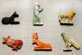 Egyptian glass amulets for luck in afterlife include jackal, baboon, ram, cows, falcon at Corning Museum of Glass. Corning, NY.