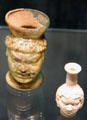 Roman mold-blown glass cup & bottle with faces at Corning Museum of Glass. Corning, NY.