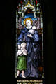 Stained glass windows with St. Vincent de Paul in Sage Chapel on Cornell Campus. Ithaca, NY.