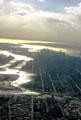 Looking down East River to Verrazano Bridge in distance from air. New York, NY.