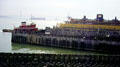 Staten Island Ferry docks with Verrazano Narrows bridge in distance. New York, NY.