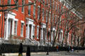 Row of uniform heritage townhouse now used by NYU on northeast edge of Washington Square. New York, NY.