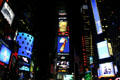 Times Square lights at night with One Times Square in center. New York, NY