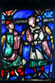 Stained glass shows Saint Nicholas bishop of Myra saving three innocent Roman soldiers condemned to death from cathedral in Soissons, France at The Cloisters. New York, NY.