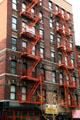 Heritage building with orange fire escapes. New York, NY.