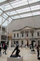 Sculpture gallery seen against Greek revival Bank of the United States building front under skylight at Metropolitan Museum of Art. New York, NY
