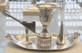 Silver candleholder with snuffer & douter by Joseph Lownes of Philadelphia at Metropolitan Museum of Art. New York, NY.