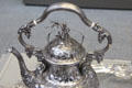 Detail of silver tea kettle with Zeus holding lightning bolt symbolic of electricity for telegraph company to which it was presented by John C. Moore of New York City at Metropolitan Museum of Art. New York, NY.
