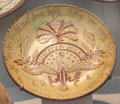 Redware sgraffito plate noting electoral victory of James Polk by Samuel Troxel of Upper Hanover Township, PA at Metropolitan Museum of Art. New York, NY.