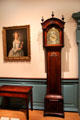 Tall clock beside card table both from Newport, RI by John Townsend at Metropolitan Museum of Art. New York, NY.