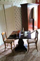 Folding card table & lap desk with late classical style wardrobe beyond at Lindenwald. Kinderhook, NY.