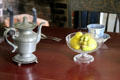 Metal teapot & glass bowl in Conklin House at Old Bethpage Village. Old Bethpage, NY.