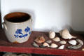 Stoneware crock & sea shells in lean-to of Conklin House at Old Bethpage Village. Old Bethpage, NY.