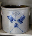 Stoneware crock by Brown Brothers of Huntington, Long Island with cobalt blue crossed feathers in Layton General Store at Old Bethpage Village. Old Bethpage, NY.