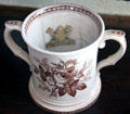 Two handled cup with frog sculpture inside at Home Sweet Home Museum. East Hampton, NY.