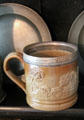 Brown salt glaze cup with embossed hunting scene at Home Sweet Home Museum. East Hampton, NY.
