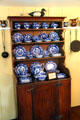 Open shelf display cupboard with blue & white antique dishes at Home Sweet Home Museum. East Hampton, NY.