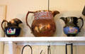 Copper lusterware pitchers with embossed designs at Home Sweet Home Museum. East Hampton, NY.