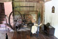 Spinning wheel in front of brick fireplace with ladder-back sidechair at Thomas Halsey Homestead. South Hampton, NY