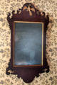 Early American wall mirror with cutout wooden frame & American eagle at Thomas Halsey Homestead. South Hampton, NY.