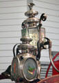 Detail of decorated lamps on fire hose cart at carriage collection of Long Island Museum. Stony Brook, NY.
