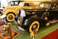 Packard Fifteenth Series, 1508 Invalid Sedan equipped with factory wheel chair fitted for right rear seat from Detroit, MI & Lincoln Model K, Series 300 convertible coupe in background at Canton Classic Car Museum. Canton, OH.