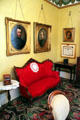 Settee with family portraits in library at Kelton House Museum. Columbus, OH.