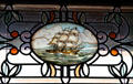 Stained glass window with sailing ship in transom of Flavel House. Astoria, OR.