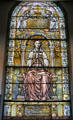Stained glass window of praying woman commemorating Mary Rhinelander Stewart by Tiffany at Trinity Church. Newport, RI.