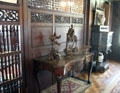 Detail of Dining Room screen with Chinese sculptures on side table at Kingscote. Newport, RI.