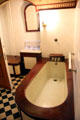 Bathroom with wood-framed tub at Chateau-sur-Mer. Newport, RI.