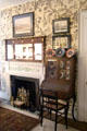 Fireplace & writing desk in bedroom with branches wallpaper at Chepstow. Newport, RI.