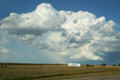 Clouds over hay bails & South Dakota sign. SD.