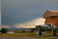 Storm in distance beyond Beech C-45 at South Dakota Air & Space Museum. SD.