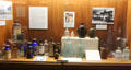Collection of antique medicine bottles in lobby at Houston City Hall. Houston, TX.
