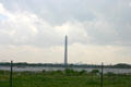 San Jacinto monument beside Texas ship channel with petroleum refinery beyond. Houston, TX.