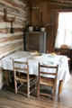Table & cow-hide seats in Walton-Smith log cabin at Pioneer Museum. Fredericksburg, TX.