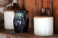 Stoneware jugs & ceramic pitcher in Walton-Smith log cabin at Pioneer Museum. Fredericksburg, TX.