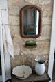 Exterior washbasin, pitcher, comb case & mirror at Sauer-Beckmann Farmstead. Stonewall, TX.
