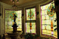 Conservatory with art glass windows with Art Nouveau motifs at McFaddin-Ward House. Beaumont, TX.