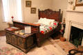 Bedroom with carved bed & painted chest at McCulloch House. Waco, TX.