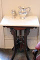 Side table with silver pitcher & chalice at East Terrace House. Waco, TX.