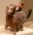 Ceramic Nazca-culture single-spout strap-handle vessel of masked feline from south coast, Peru at Dallas Museum of Art. Dallas, TX.