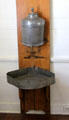 Water dispenser with drip pan in kitchen at French Legation Museum. Austin, TX.