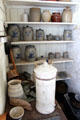 Pantry with stoneware crocks in Bell House kitchen at Pioneer Farms. Austin, TX.